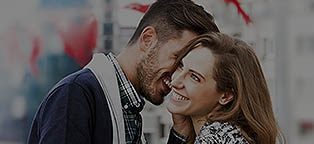 man whispering in woman's ear 